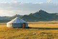 A traditional yurt stands in a vast open field surrounded by majestic mountains, A traditional yurt nestled in the vast Mongolian