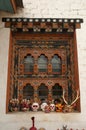 Traditionally decorated window and wooden masks, Thimpu, Bhutan Royalty Free Stock Photo