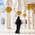 Traditionally dressed arabic woman wearing black burka wisiting Sheikh Zayed Grand Mosque in Abu Dhabi, United Arab Royalty Free Stock Photo