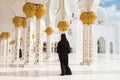 Arabic woman in black burka in Sheikh Zayed Grand Mosque, Abu Dhabi, UAE. Royalty Free Stock Photo