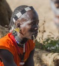 Traditionally dressed Hamar man with chewing stick in his mouth. Turmi, Omo Valley, Ethiopia.
