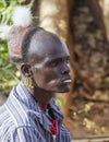 Traditionally dressed Hamar man with chewing stick in his mouth. Turmi, Omo Valley, Ethiopia.