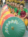 Traditionally dressed Indonesian girls with parasols