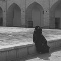 Traditionally dressed older woman in a chador front of Jameh Mosque, Masjed-i Jame` Mosque, Yazd, Iran