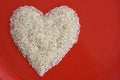 Indian raw basmati Rice heart shape in a red plate used to make biryani or pulao Royalty Free Stock Photo