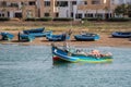 An traditionally painted small fisher boat in the harbor of Rabat