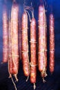 Traditionally smoked sausage meat is hung in traditional smokehouses while Royalty Free Stock Photo