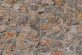 Traditionally woven, natural stone wall texture in shades of gray and orange. High-resolution stone surface ideal for construction Royalty Free Stock Photo