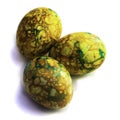 Handmade yellow green easter eggs painted marbled over white background