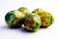 Handmade yellow green easter eggs painted marbled over white background