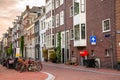 Tradtional townhouses along a street in Amsterdam at sunset