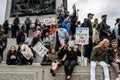 TRAFALGAR SQUARE, LONDON/ENGLAND- 29 August 2020: Protesters sat on the steps of Nelson`s Column at the Unite for Freedom rally Royalty Free Stock Photo