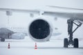 Airplane at airport during heavy snowfall Royalty Free Stock Photo