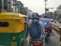 In a Traffic Auto Rickshaw and Bike, Bike Rider with Helmet Waiting for a Green Signal