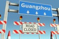 Traffic barricades near Guangzhou city traffic sign. Lockdown in China conceptual 3D rendering