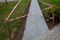 Traffic barrier against entering a new threshing road. the path is made of ground gray stone compacted with a vibrating plate. Sta Royalty Free Stock Photo