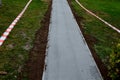 Traffic barrier against entering a new threshing road. the path is made of ground gray stone compacted with a vibrating plate. Sta Royalty Free Stock Photo