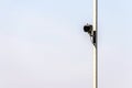 Traffic camera on metal pole over bright sky background in british town Royalty Free Stock Photo