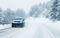 Traffic car on winter road in snow blizzard Royalty Free Stock Photo