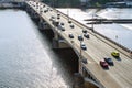 Traffic of cars across the bridge, the Vltava River. Panoramic view of architectural buildings.