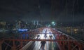 Traffic cars over the Brooklyn Bridge. Against the backdrop of the silhouette of the night in New York Royalty Free Stock Photo