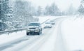 Traffic cars on winter road in snow blizzard Royalty Free Stock Photo