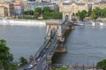 The traffic on the Chain bridge in Budapest with Gresham Palace in the background Royalty Free Stock Photo