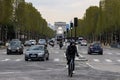 Traffic on Champs-Elysees Avenue with Arc de Triomphe in the background. Paris, France.