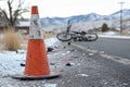 Traffic cone marking bicycle accident scene on mountain road Royalty Free Stock Photo