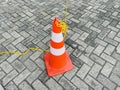 Traffic cone on a paved street with interlocking gray bricks Royalty Free Stock Photo