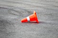 Traffic cone tipped over on pavement