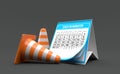 Traffic cones with calendar isolated on grey background