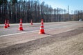 Traffic cones were installed on the roadway. Road works in the spring. Construction cone or road cone. Safety pylon, with white Royalty Free Stock Photo