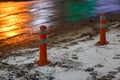 Traffic cones at winter night city with snow and footprints Royalty Free Stock Photo