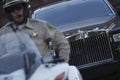 Traffic Cop Sitting On Motorbike With Car In Background Royalty Free Stock Photo