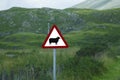 Traffic sign, sheep on white background with red triangle in the Highlands of Scotland
