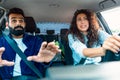 Traffic danger. Stressed arab couple having risk of road accident, woman driving car Royalty Free Stock Photo