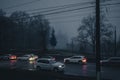 Traffic in the evening in the fog against the background of a prayer house in the city of Vinnitsa, Ukraine