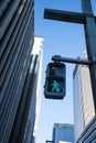 Traffic green light for people, pedestrian and human to cross the street with background of office building skycrapper in Tokyo, Royalty Free Stock Photo