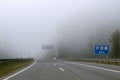 Car driving on highway in heavy fog. Traffic safety in heavy fog.