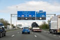 Traffic and illegible direction signs on highway A27 from Utrecht to Amsterdam