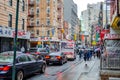 Traffic Jam at China Town New York City on a rainy winter day with People walking with umbrellas on sidewalk