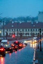 Traffic jam in the city at night during the rain. Rear view of cars standing on the road and red headlights. Reflection of red car Royalty Free Stock Photo