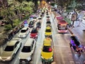 Traffic jam on the road in Bangkok at night. Top view of a wide street with multi-lane traffic, Heavy traffic from colorful cars.