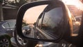 Traffic jam on road view through wing mirror car with sunset behind Royalty Free Stock Photo