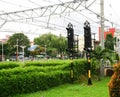 Traffic lamp light for train commuter line with tree and green bush electric cable in bogor indonesia