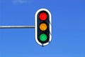 traffic light in blue sky with red, yellow and green lights Royalty Free Stock Photo