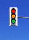 traffic light in blue sky with red, yellow and green lights Royalty Free Stock Photo