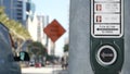 Traffic light button on pedestrian crosswalk, people have to push and wait. Traffic rules and regulations for public safety in USA