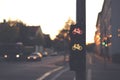 traffic light for a cycling lane showing red and yellow bicycle symbol at a frequented intersection in dark early morning light